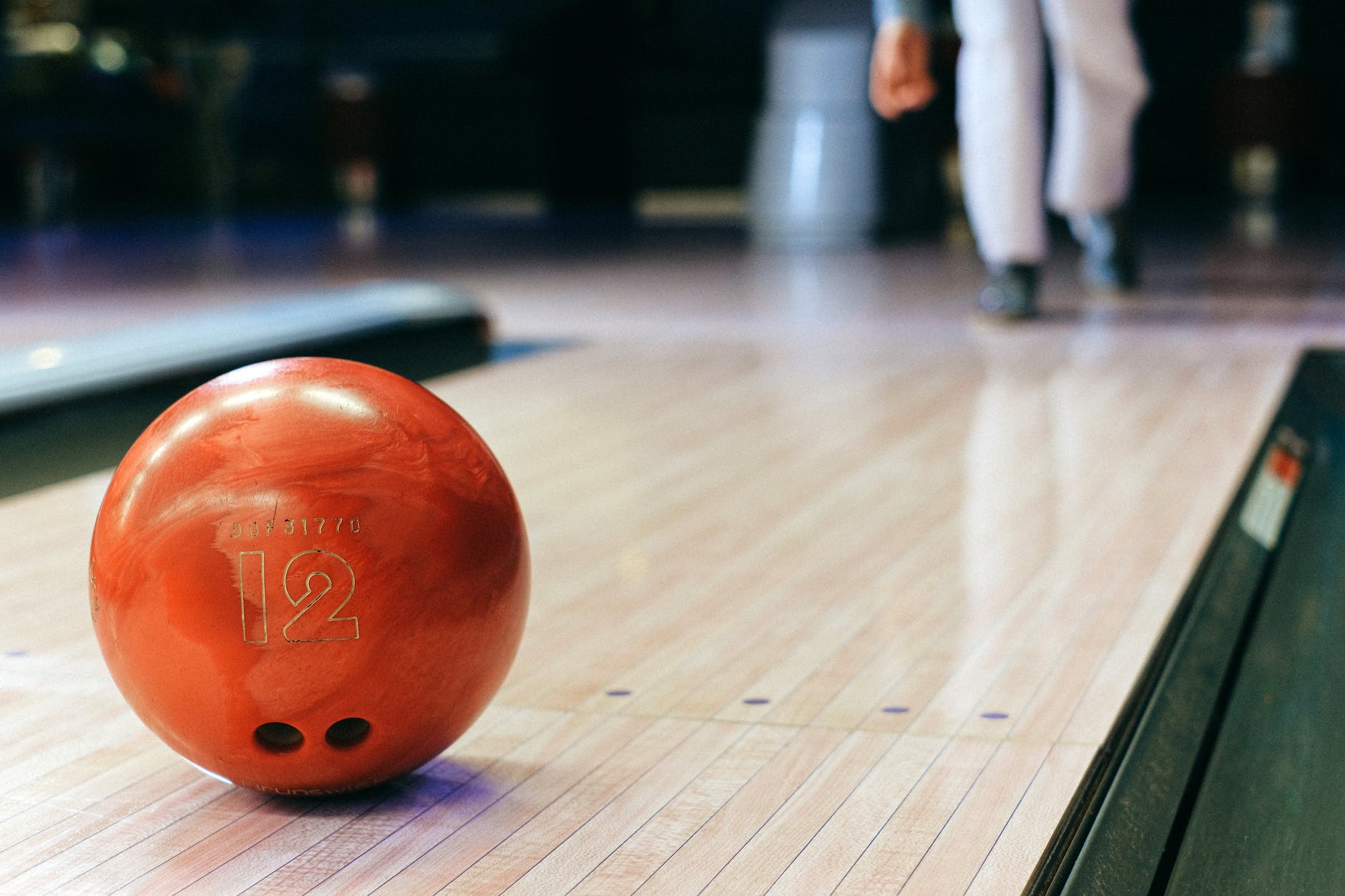 close up shot of a brown bowling ball on the bowling alley